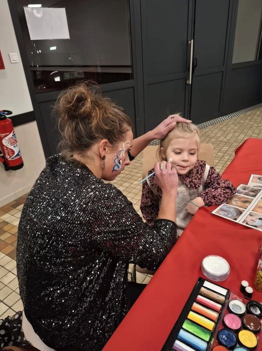 Céline en train de maquiller une petite fille